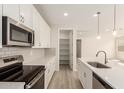 Well-appointed kitchen showcasing a stainless steel range, microwave, and spacious pantry at 18792 E Panchito Dr, Gold Canyon, AZ 85118