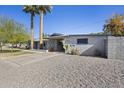 Ranch style home with gravel driveway and mature trees at 4555 N 5Th Ave, Phoenix, AZ 85013