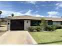 Attractive single-story home featuring a well-kept lawn and elegant front entry at 11133 W Cameo Dr, Sun City, AZ 85351