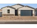 Newly built home with gray exterior, dark garage door, and stone accents at 4314 W Josephine St, San Tan Valley, AZ 85144