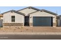 New construction home with gray exterior, dark garage door, and stone accents at 4314 W Josephine St, San Tan Valley, AZ 85144