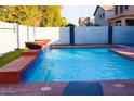 Inviting backyard pool with water feature and spacious patio at 43542 W Caven Dr, Maricopa, AZ 85138