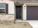 Close-up of the front entrance showcasing a stylish door and stone veneer accents at 16017 W Cottontail Ln, Surprise, AZ 85387