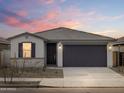 A beautifully staged single-story home with a clean desert landscape and neutral palette at 16017 W Cottontail Ln, Surprise, AZ 85387