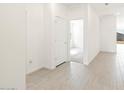 Bright hallway featuring stylish wood-look tile flooring and neutral paint at 16017 W Cottontail Ln, Surprise, AZ 85387