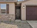 Close-up of a front entrance with a craftsman style front door, and stone accents at 16035 W Desert Hollow Dr, Surprise, AZ 85387
