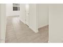 Bright hallway with tile floors, white walls, and modern trim at 16035 W Desert Hollow Dr, Surprise, AZ 85387