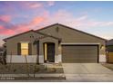 Inviting home exterior featuring a neutral color scheme under a colorful sky at 16082 W Desert Spoon Dr, Surprise, AZ 85387