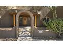 Close-up of the inviting front entrance featuring a rustic wooden door and arched entryway at 2926 W Tanya Trl, Phoenix, AZ 85086