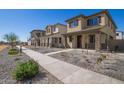 View of modern neighborhood featuring gravel landscaping and sidewalks, providing a clean and contemporary look at 15595 S 181St Dr, Goodyear, AZ 85338