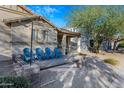 Relaxing front porch with four blue chairs and a built-in bench at 1724 S Rockwell St, Gilbert, AZ 85295