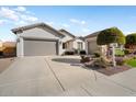 House exterior featuring a two-car garage and well-maintained landscaping at 27078 W Yukon Dr, Buckeye, AZ 85396