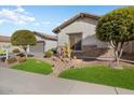 Front yard view of a charming house with attractive landscaping and stone accents at 27078 W Yukon Dr, Buckeye, AZ 85396