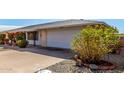 House exterior showcasing a garage and mature landscaping at 9409 W Glen Oaks N Cir, Sun City, AZ 85351