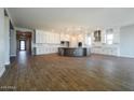 Spacious kitchen with white cabinets, a large island, stainless steel appliances, and wood-look tile flooring at 1284 E Coconino Way, Gilbert, AZ 85298