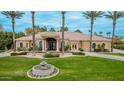 Stunning home exterior with a circular driveway, manicured lawn, decorative fountain and lush, mature landscaping at 2494 E Cloud Dr, Chandler, AZ 85249