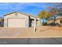 Single-story house with a two-car garage and desert landscaping at 4336 S Pony Rider Trl, Gold Canyon, AZ 85118