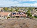 Aerial view of backyard featuring solar panels on tile roof, landscaping, and block wall at 1017 E Grandview Rd, Phoenix, AZ 85022