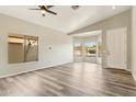 Bright living room with vaulted ceilings, modern gray vinyl flooring, and multiple windows offering natural light and neighborhood views at 6658 E San Cristobal Way, Gold Canyon, AZ 85118