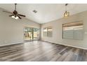 Spacious living area features a ceiling fan, vinyl flooring and a sliding door providing access to a backyard patio at 6658 E San Cristobal Way, Gold Canyon, AZ 85118