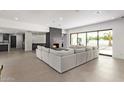 Spacious living area featuring a large sectional sofa and a modern fireplace at 9027 N 82Nd St, Scottsdale, AZ 85258