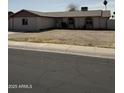 Inviting single-story home featuring a spacious front yard with minimal landscaping and a paved street view at 7127 W Vogel Ave, Peoria, AZ 85345