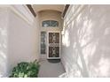 Inviting front entrance with decorative security door and neutral stucco walls at 17316 N Inca Pl, Surprise, AZ 85374