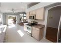 Bright kitchen featuring tile flooring, stainless steel appliances, and a breakfast nook with backyard views at 17316 N Inca Pl, Surprise, AZ 85374