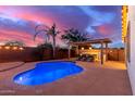 Stunning backyard with a pool, outdoor kitchen, and pergola at 21950 N 100Th Ave, Peoria, AZ 85383