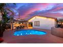 Inviting pool and patio area with a pergola and outdoor kitchen at 21950 N 100Th Ave, Peoria, AZ 85383