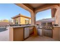 Outdoor kitchen with stainless steel grill and granite countertops at 41515 N Chase Oaks Way, Anthem, AZ 85086