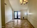 Bright living room with tiled floor, double doors and stylish chandelier at 1116 E Belmont Ave, Phoenix, AZ 85020