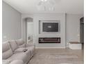 Living room with fireplace and view into adjacent room at 4287 E Clifton Ave, Gilbert, AZ 85295