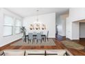 Bright dining room featuring a modern chandelier, elegant table set, and decorative wall art at 17006 N 44Th Pl, Phoenix, AZ 85032