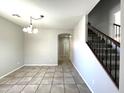 Bright dining room with tile floors and access to the kitchen and stairs at 17323 W Woodlands Ave, Goodyear, AZ 85338