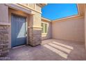 Private courtyard entry with a blue door and stone pillars at 19026 W Ocotillo Rd, Waddell, AZ 85355