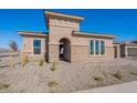 Modern home with stone accents and an arched entryway at 19026 W Ocotillo Rd, Waddell, AZ 85355