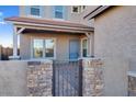 Front entry with stonework, gate, and light blue door at 5923 N 83Rd Ln, Glendale, AZ 85305