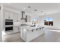 Modern kitchen featuring white cabinets, quartz countertops, and stainless steel appliances at 5923 N 83Rd Ln, Glendale, AZ 85305