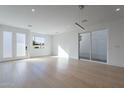 Bright, airy living room featuring light hardwood floors and a modern light fixture at 2130 E Turney Ave # 4, Phoenix, AZ 85016