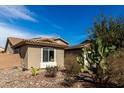 This beautiful home features desert landscaping, a tile roof, and neutral stucco at 22004 W Moonlight Path, Buckeye, AZ 85326