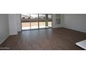 Living room with sliding glass doors that open to the spacious, flat backyard at 12311 W Parkway Ln, Avondale, AZ 85323