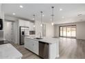 Open-concept kitchen featuring stainless steel appliances, gray backsplash, and a view of the dining area at 18746 E Panchito Dr, Gold Canyon, AZ 85118