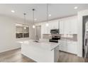 Modern kitchen features white cabinets, stainless steel appliances, quartz countertops and pendant lighting at 18746 E Panchito Dr, Gold Canyon, AZ 85118
