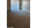 Bright living room featuring carpeted floors and access to outdoor space at 3131 W Cochise Dr # 149, Phoenix, AZ 85051