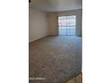 Spacious living room with carpeted floors and sliding glass door at 3131 W Cochise Dr # 149, Phoenix, AZ 85051