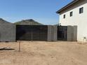 Modern driveway gate surrounded by block fence against a mountain backdrop at 3295 W Mesquite St, Phoenix, AZ 85086