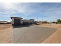 Single-story home with a large brick paved drive and three-car garage at 3295 W Mesquite St, Phoenix, AZ 85086