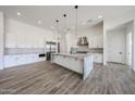 Spacious white kitchen with stainless appliances and a large center island at 3295 W Mesquite St, Phoenix, AZ 85086