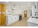 Modern kitchen showcasing white cabinets, quartz countertops, and stainless steel appliances, bathed in natural light at 3155 W Augusta Ave, Phoenix, AZ 85051